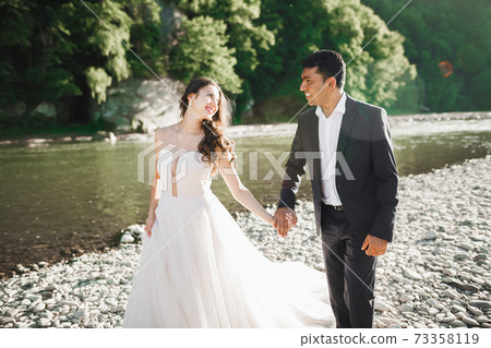 Wedding couple holding hands, groom and bride together on wedding day 73358119