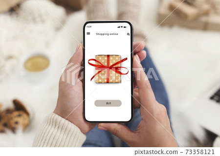 Woman using mobile phone and ordering purchase on internet 73358121