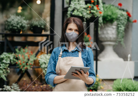 People, business, technology, sale and floristry. Serious young woman writes message People, business, technology, sale and floristry. Serious young woman writes message 73358252