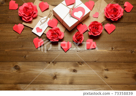 Love, Valentine's, women's day, relations, romantic design with gifts and envelope, wrapped in brown craft paper, tied with twine with bows, labels, handmade paper roses and hearts on wooden boards Love, Valentine's, women's day, relations, romantic design with gifts and envelope, wrapped in brown craft paper, tied with twine with bows, labels, handmade paper roses and hearts on wooden boards 73358839