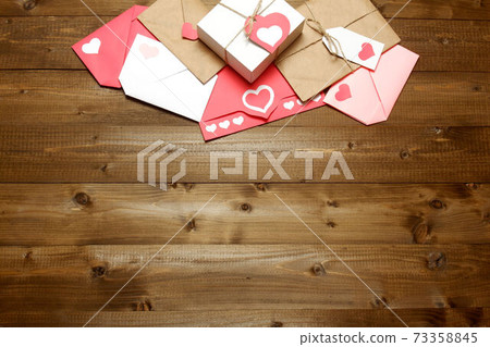 Love, Valentine's, women's day, relations, romantic composition from gifts and love letters, colored and wrapped in craft paper, tied with twine with bows and labels, hearts on wood background Love, Valentine's, women's day, relations, romantic composition from gifts and love letters, colored and wrapped in craft paper, tied with twine with bows and labels, hearts on wood background 73358845