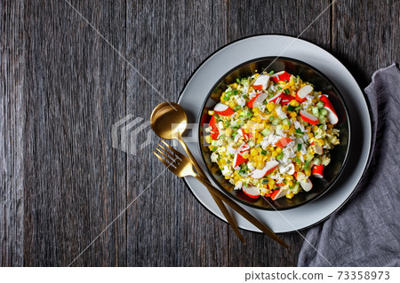 Crab salad with vegetables on a plate, copy space Crab salad with vegetables on a plate, copy space 73358973