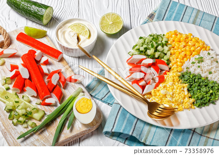 Crab salad of surimi sticks on a white plate 73358976