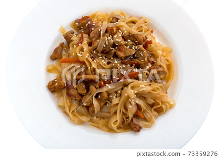 Noodles wok on a white plate. Rice noodles cooked in wok on a white plate. Noodles wok on a white plate. Rice noodles cooked in wok on a white plate. 73359276