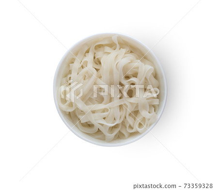Rice noodles in a plate. Boiled rice noodles in a plate on a white background.Top view 73359328