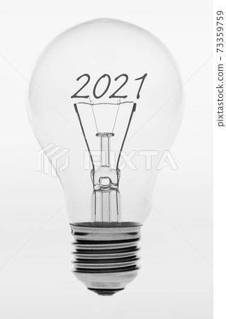 Old fashioned light bulb with the text two thousand and twenty one. Old fashioned light bulb with the text two thousand and twenty one. 73359759