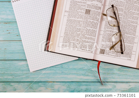 Opened the Holy Bible close up prayer time on notepad 73361101
