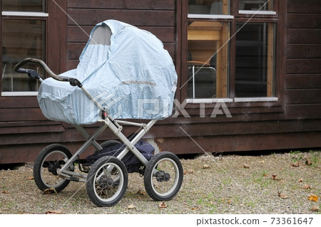 Baby taking a typical nap outside in a landau in Denmark, Scandinavia  73361647