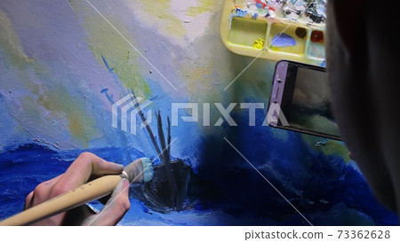 Artist copyist paint seascape with ship in ocean. Craftsman decorator draw as boat sail on blue sea. In hand of cellphone tablet computer pc. Artist copyist paint seascape with ship in ocean. Craftsman decorator draw as boat sail on blue sea. In hand of cellphone tablet computer pc. 73362628