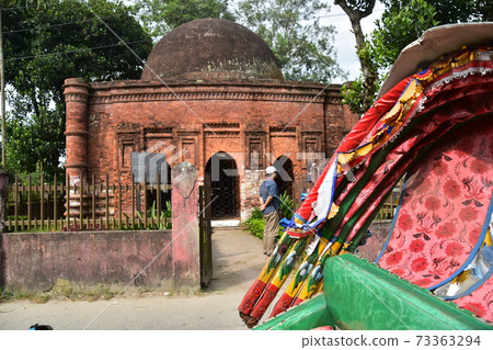 Sional Gao in Dhaka, Bangladesh A man sightseeing with the historic Goardi Mosgit and a parked rickshaw 73363294