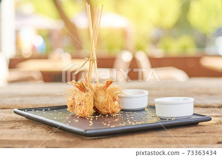Crispy shrimps on blurred background. Crispy shrimps on blurred background. 73363434