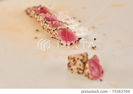 Roast tuna sliced on table. 73363709