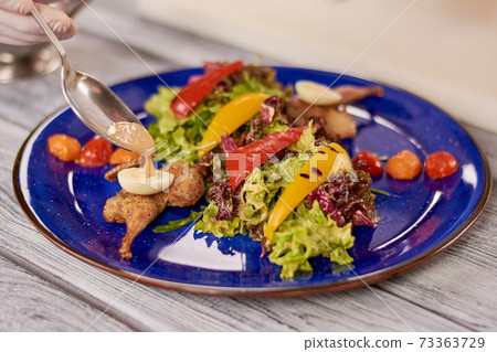 Appetizing salad with quail and vegetables. 73363729