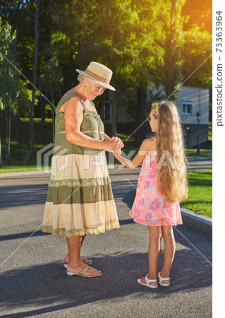 Senior woman smiling to granddaughter. Senior woman smiling to granddaughter. 73363964