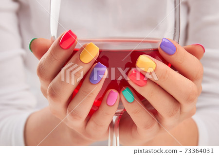 Big glass of wine in manicured hands. Big glass of wine in manicured hands. 73364031