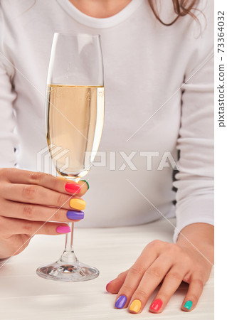 Young woman hands with glass of champagne. Young woman hands with glass of champagne. 73364032