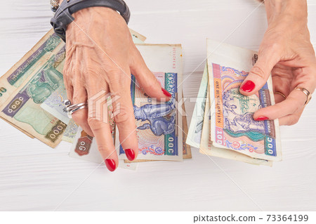 Woman hands counting kyat money. 73364199