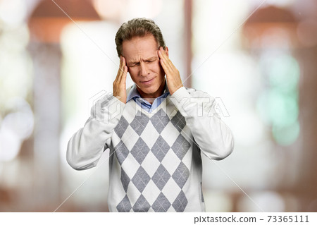Mature man suffering from headache. 73365111