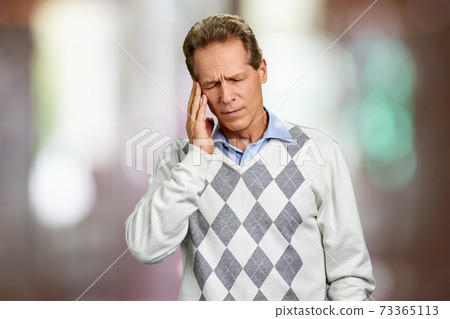 Mature man suffering from migraine. Mature man suffering from migraine. 73365113