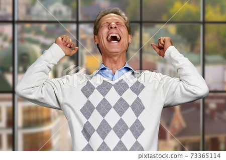 Man clenched his fists in excitement. Man clenched his fists in excitement. 73365114