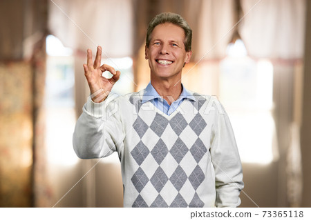Smiling man showing okay with fingers. Smiling man showing okay with fingers. 73365118