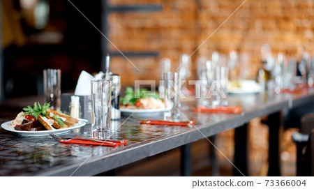 interior of the cafe, in the evening in brown tones, with dishes and furniture 73366004