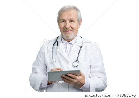 Portrait of an old senior smiling doctor with tablet. Portrait of an old senior smiling doctor with tablet. 73366170