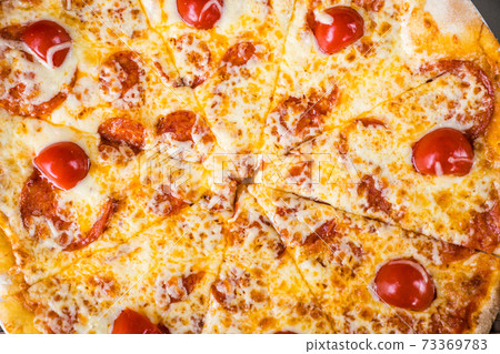 pepperoni pizza with cheese and tomatoes. ordering food at home. 73369783
