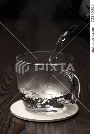 Plain hot water boiled in an iron kettle Plain hot water boiled in an iron kettle 73370399