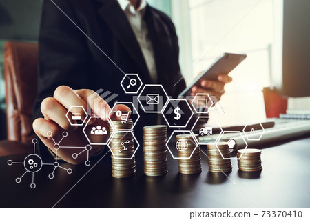 Business hand using laptop, tablet and smartphone in office. Digital marketing media mobile app in virtual icon screen Business hand using laptop, tablet and smartphone in office. Digital marketing media mobile app in virtual icon screen 73370410