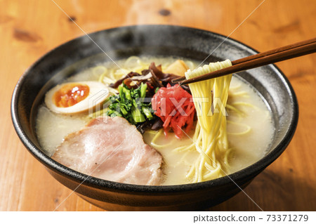 Tonkotsu ramen lifted with chopsticks 73371279