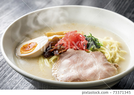 Pork bone ramen served in a white bowl Pork bone ramen served in a white bowl 73371345