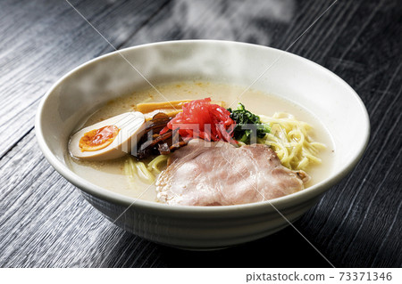 Pork bone ramen served in a white bowl Pork bone ramen served in a white bowl 73371346