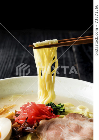Pork bone ramen lifted with chopsticks 73371366