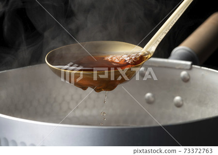 Scoop the soup stock with a ladle Scoop the soup stock with a ladle 73372763