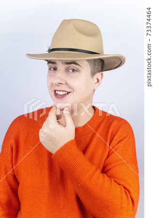 A man with painted lips, wearing women's clothing and makeup, stands in front of a mirror and admires himself. Protecting the rights of the LGBT community and openly manifesting homosexuality. 73374464