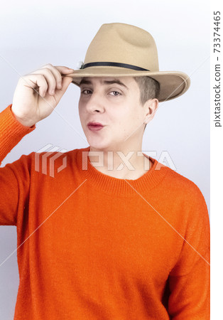 A man with painted lips, wearing women's clothing and makeup, stands in front of a mirror and admires himself. Protecting the rights of the LGBT community and openly manifesting homosexuality. 73374465