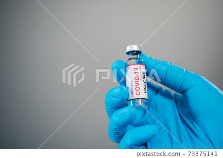 hand holding Coronavirus (Covid-19) vaccine bottle for injection medicine hand holding Coronavirus (Covid-19) vaccine bottle for injection medicine 73375141