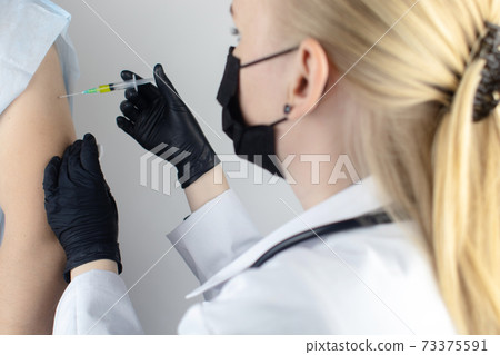 An allergist in the laboratory conducts an allergy prick-test. Skin test for household, food, epidermal allergic reactions. The test is performed on the patient back An allergist in the laboratory conducts an allergy prick-test. Skin test for household, food, epidermal allergic reactions. The test is performed on the patient back 73375591