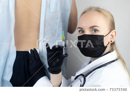 An allergist in the laboratory conducts an allergy prick-test. Skin test for household, food, epidermal allergic reactions. The test is performed on the patient back An allergist in the laboratory conducts an allergy prick-test. Skin test for household, food, epidermal allergic reactions. The test is performed on the patient back 73375598