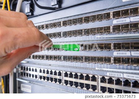 hand with fiber optic cable hand with fiber optic cable 73375673