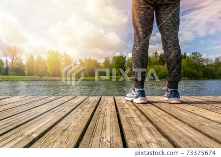 Man standing on the edge of pier 73375674