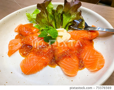 Fresh salmon slices with spicy sauce Fresh salmon slices with spicy sauce 73376569