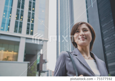 Business woman and building Business woman and building 73377592