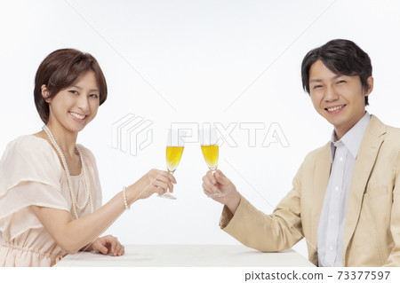 Japanese couple drinking with champagne Japanese couple drinking with champagne 73377597