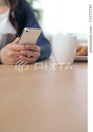 Women handling smartphone Women handling smartphone 73377747