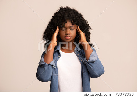 Upset african american lady having headache, grey background Upset african american lady having headache, grey background 73378356