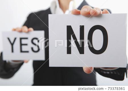 Business woman with YES and NO cards 73378361