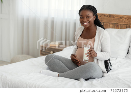 Healthy Drink. Beautiful Pregnant Woman Holding Glass Of Milk And Touching Belly Healthy Drink. Beautiful Pregnant Woman Holding Glass Of Milk And Touching Belly 73378575