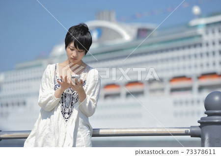 A woman operating a smartphone 73378611